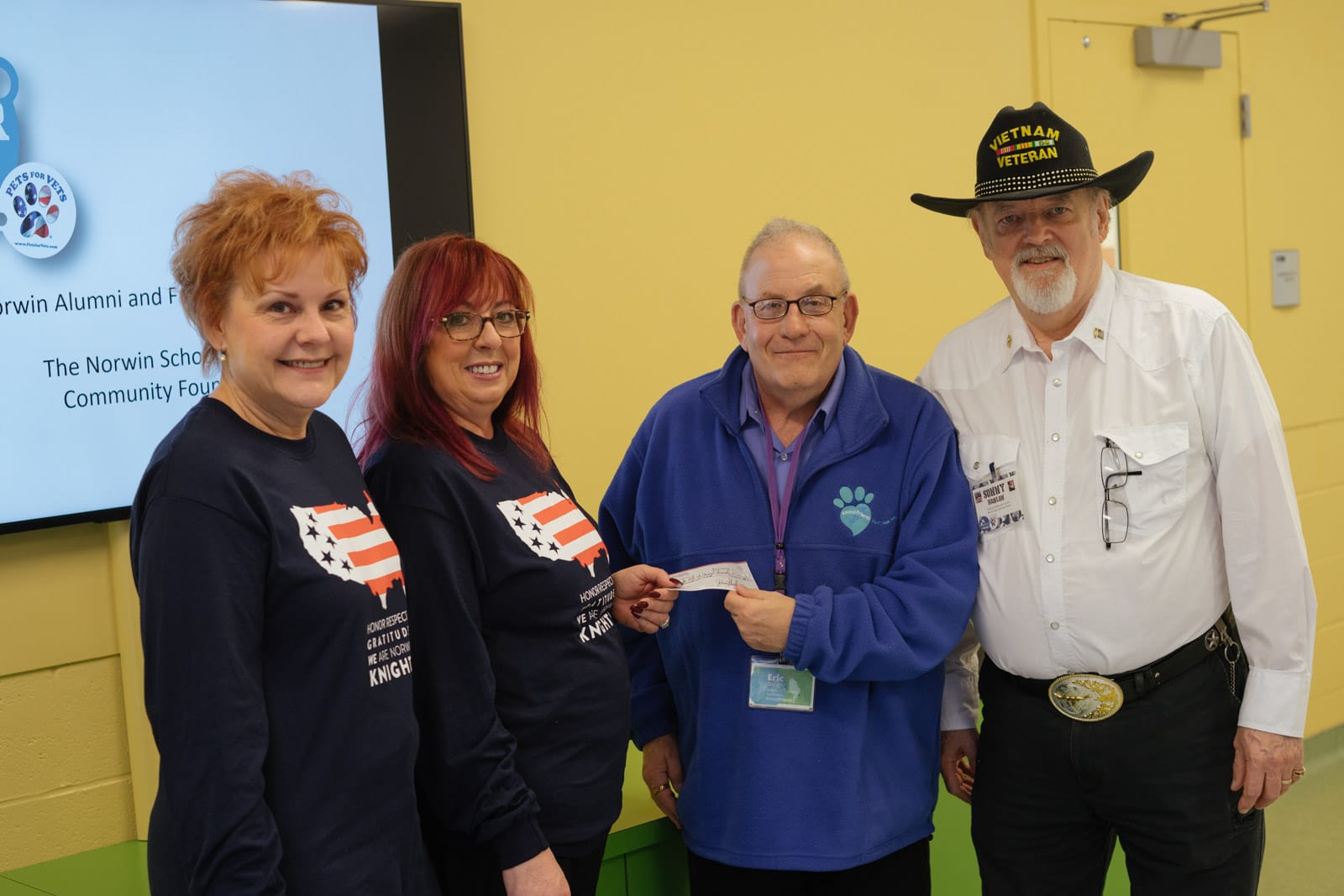 From left to right: Jo Ann Stoecklein, NAFA Treasurer; Debbie Kunkle, NAFA President; Eric Sieglitz, Pets for Vets; Sonny, Pets for Vets